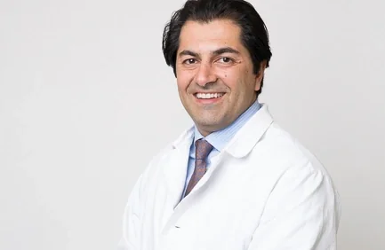 Dr. Abdy Moshrefi, periodontist, in his white coat.